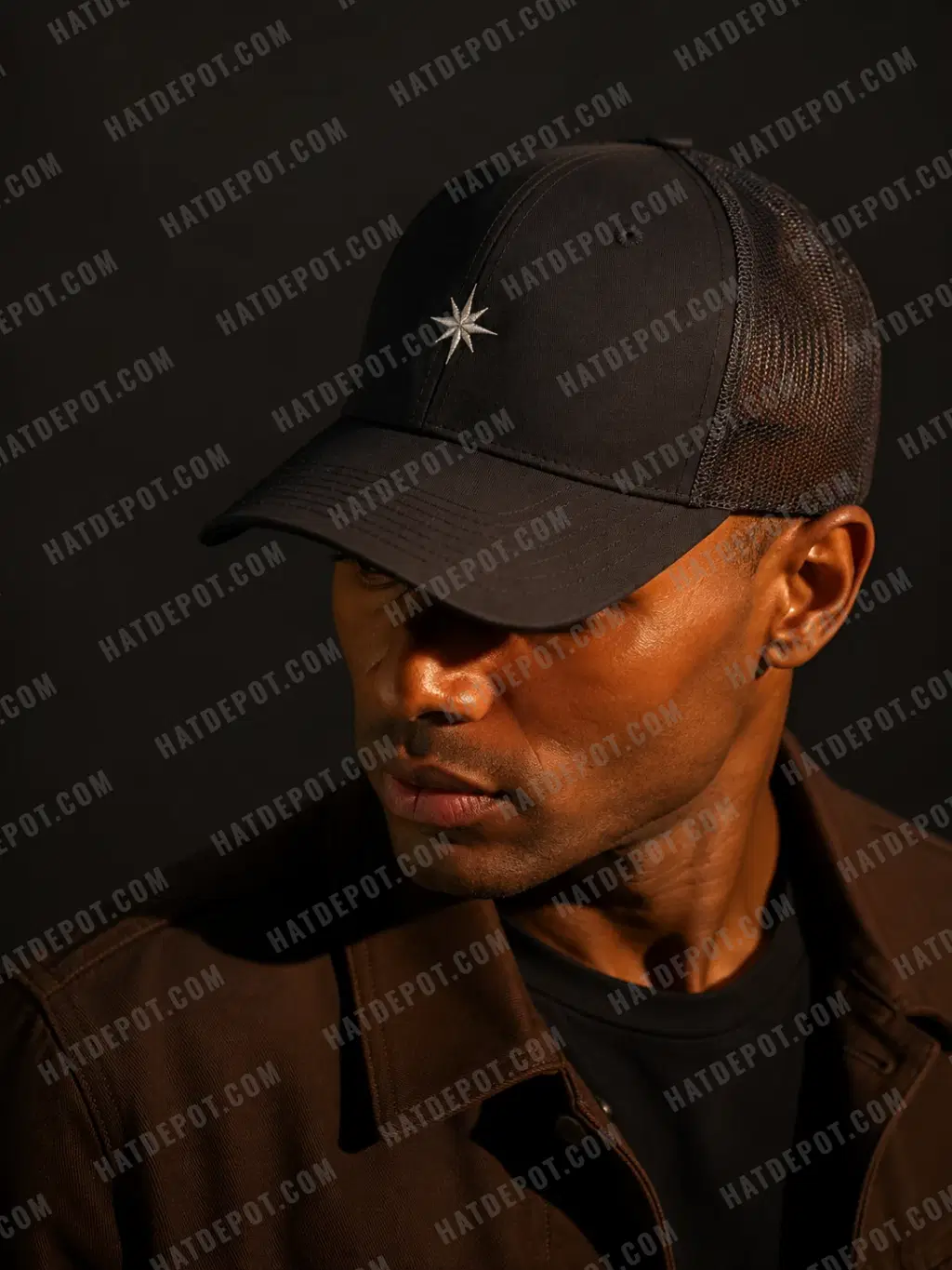 A close profile of a model wearing ivory sample embroidery on a black curved-brim cap