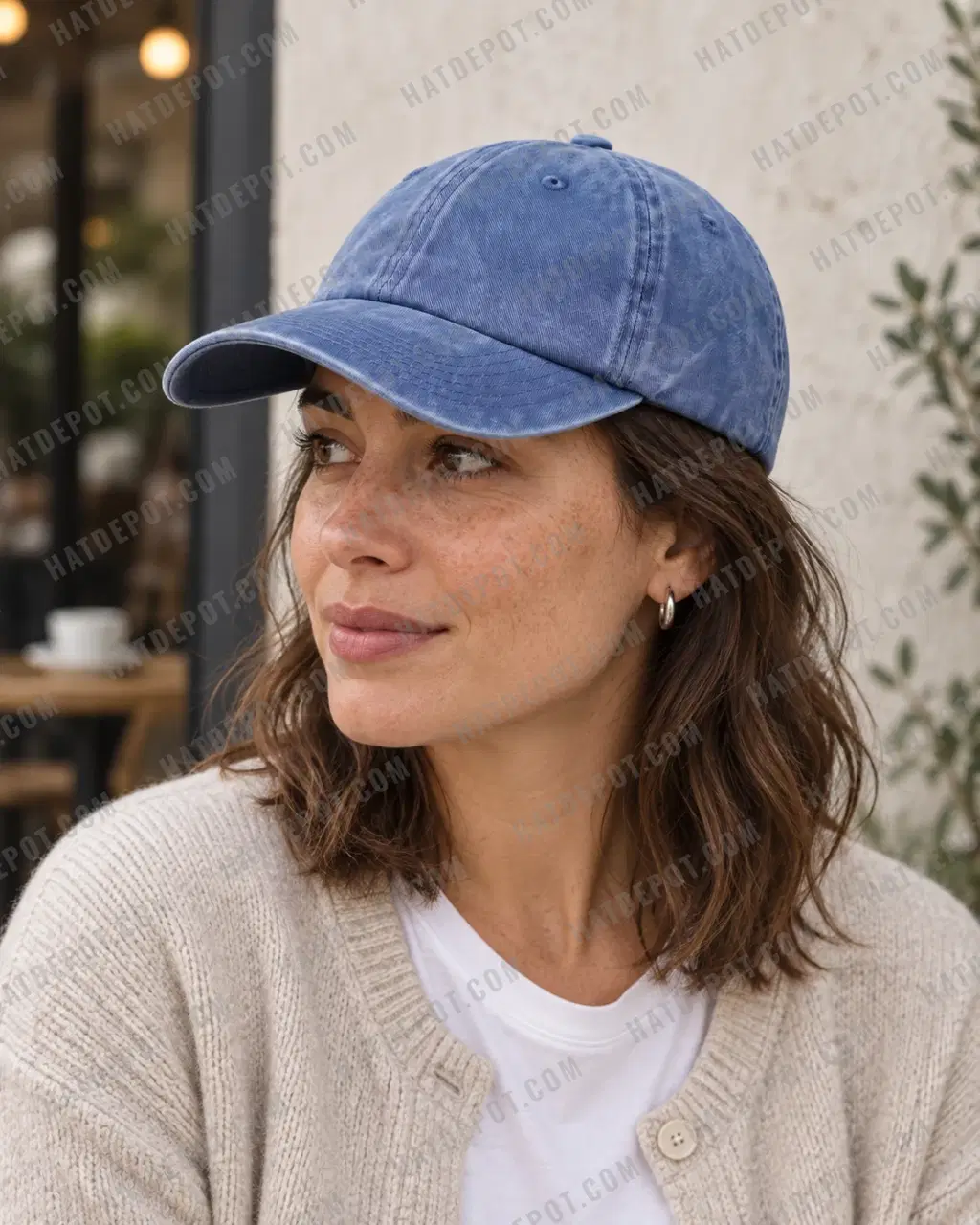 Daylight three-quarter profile of a model in the denim Pigment-Dyed Washed Dad Hat, showing the low soft crown, front seam, sewn eyelets and washed curved brim.
