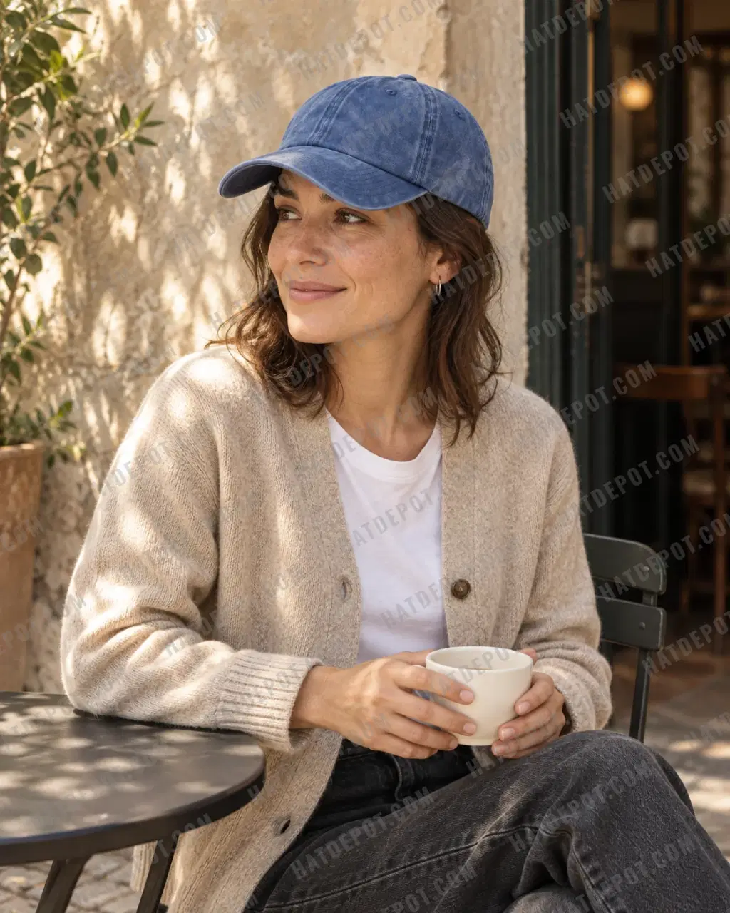 Model enjoying coffee outside a neighbourhood café in the denim Pigment-Dyed Washed Dad Hat, with its soft washed-blue crown and curved brim.